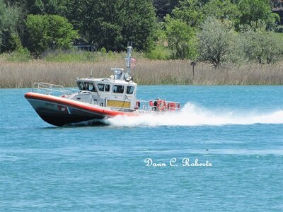 USCG boat making waves as she responds to a call from a pleasure craft.
