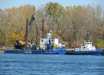 Tug Escorte and work barge Ocean Basque 2 were moored on the Canadian side of the river.  I had to guess at the name of the barge, since part of its name is covered by the tire.
