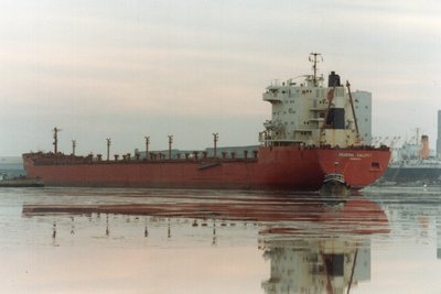 Federal Calumet outbound from the then Farmers Union-GTA Elevator Gallery dock, Superior. Assisted by North American tugs<br />Dakota and Sioux.