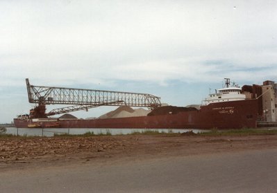 Unloading at the CLM dock, Superior. Bumboats Marine Trader and Kaner I along side.