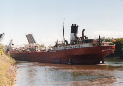 Heading thru the Memorial Street(US-31) Bridge, Manistee, MI heading to Akzo Salt with a load of coal. 9/2/90.