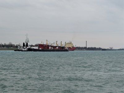 Down-bound tug Michigan with barge Great Lakes (Quebec City) meets Federal Leda as American Integrity (Duluth) fuels up in the background.