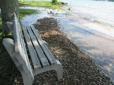 Care to sit and cool your feet? There used to be a grassy swath between the bench and a sandy beach.
