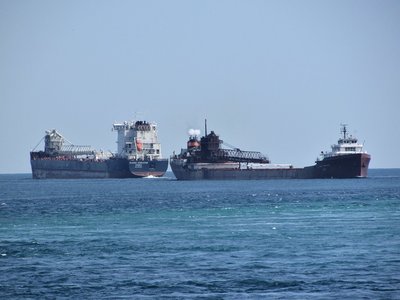 Algoma Innovator and Lee A. Tregurtha (AK/Rouge) pass above the Bluewater Bridges.