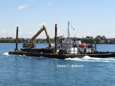 Manitou quickly picks up her work barge and heads back up river to continue dredging operations.