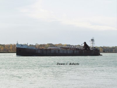 Tug Laura L. VanEnkevort (Stoneport) with signs of a previous limestone cargo on the side of her barge.
