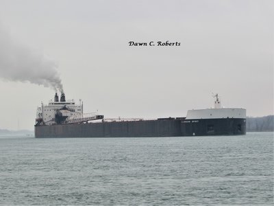 American Spirit (Cleveland) trailing her scrubber plume as she passes the (temporarily closed) River Crab Restaurant.