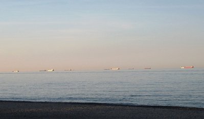 The setting sun reflects off salties still waiting for pilots, in the Lake Huron anchorage