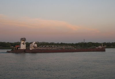 As daylight fades, she heads downbound with an unspecified cargo and destination