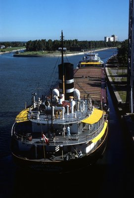 Misener Str. 'George M. Carl' sliding down Lock Wall to Lock 8 - Welland Canal in 1877 - Note (pointed) Rudder-Control Bar on Main Deck -- Stern..jpg