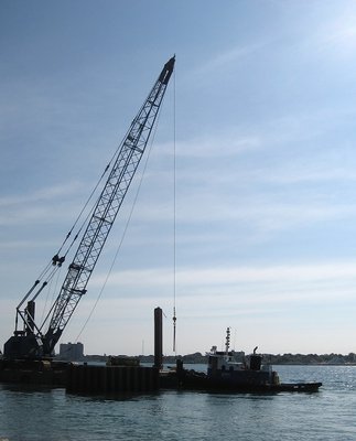 Early morning silhouette of tug Andrew J and work barge along the Blue Water Riverwalk, at Port Huron.