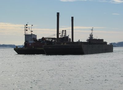 Inching her barges toward a dock above Marysville.