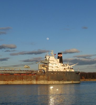 The nearly full moon hangs above Algoma Olympic's pilot house.