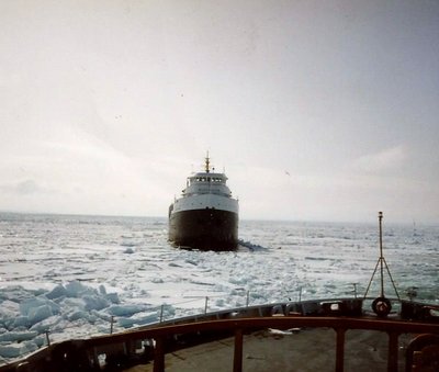 USCGC Mackinaw backing up to the Beechglen to clear ice from their path