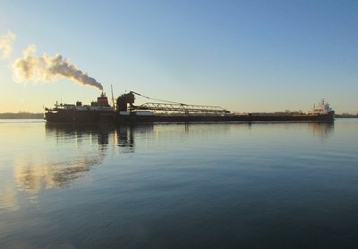Hon. James L. Oberstar reflected in early morning light with taconite for the AK Rouge plant.